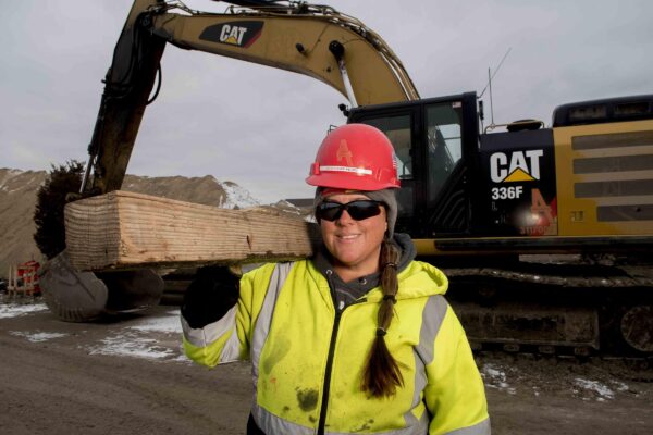 Female union laborer working road construction in winter