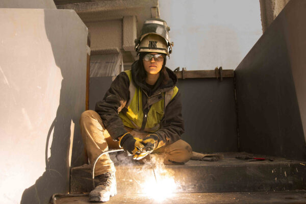 Female iron worker welding