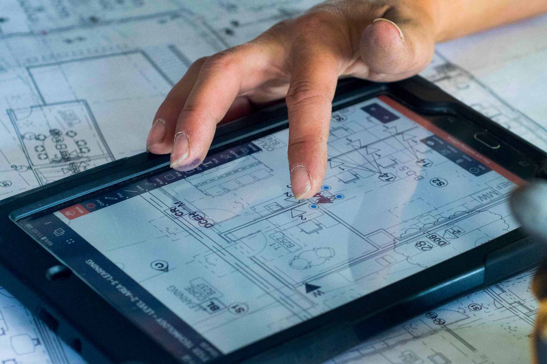 Female carpenter uses tablet computer on construction site