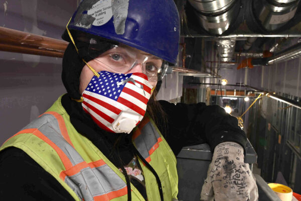 woman insulator with red white and blue N95 mask