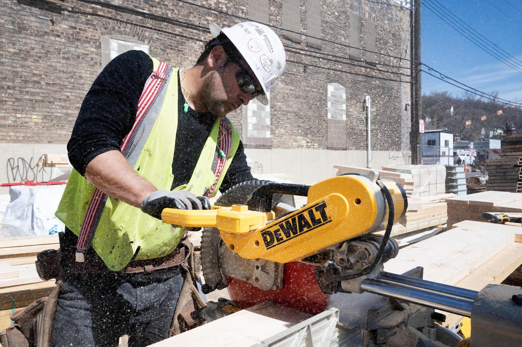 Union carpenter sawing with a DeWalt saw