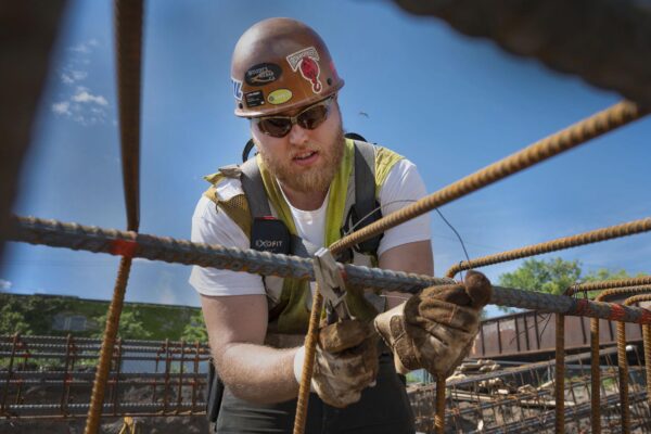 Iron worker constructing with rebar