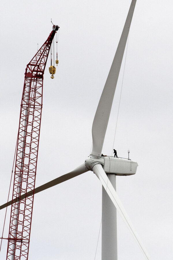 Wind farm construction worker on top of turbine