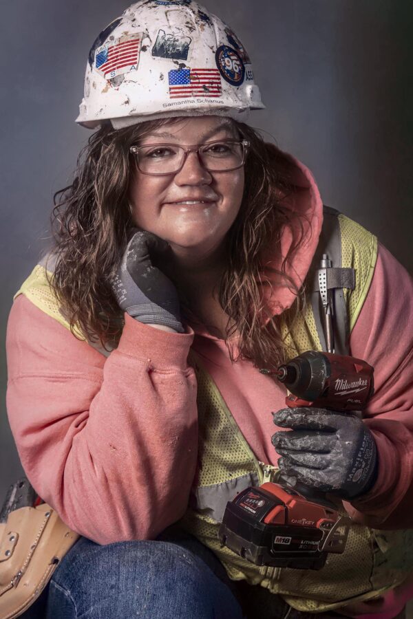 Female roofer holding Milwaukee drill