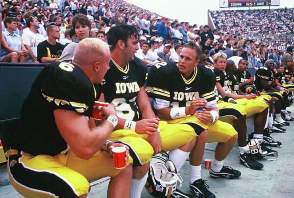 Big 10 Iowa Hawkeyes Football players talking on bench